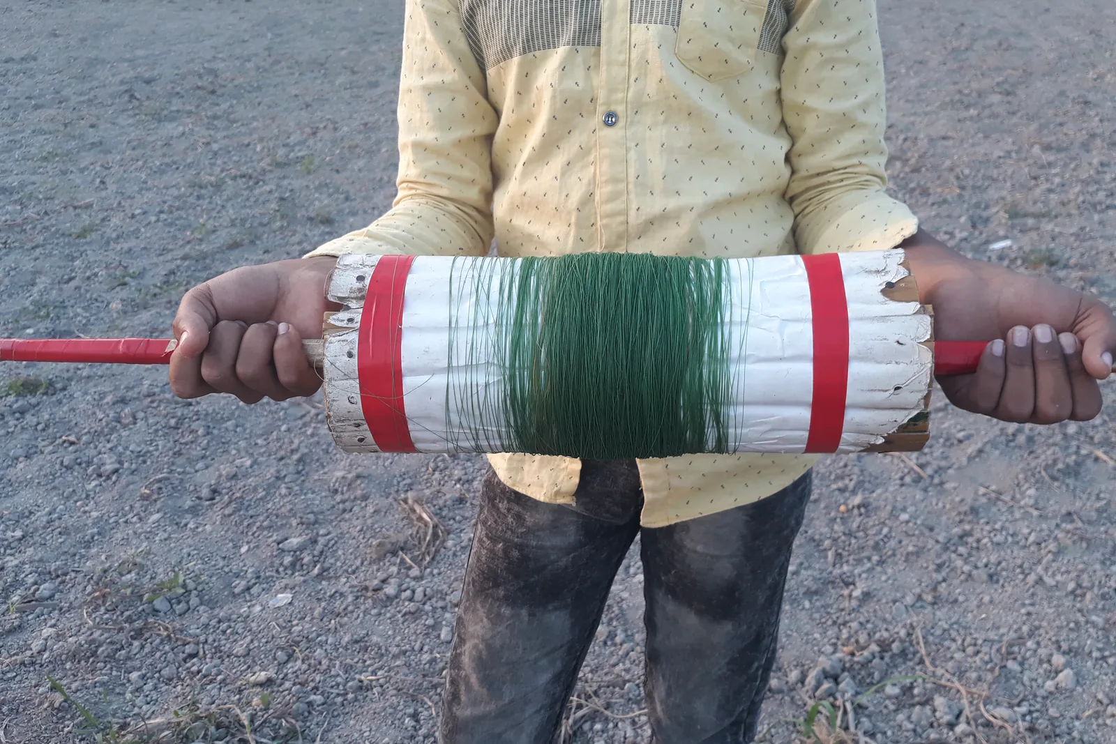 Handmade kite reel held outdoors