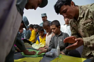 People working together at a kite-making activity table