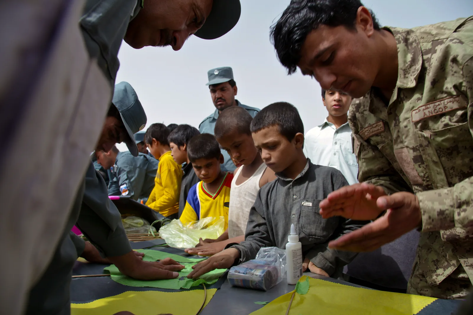 People working together at a kite-making activity table